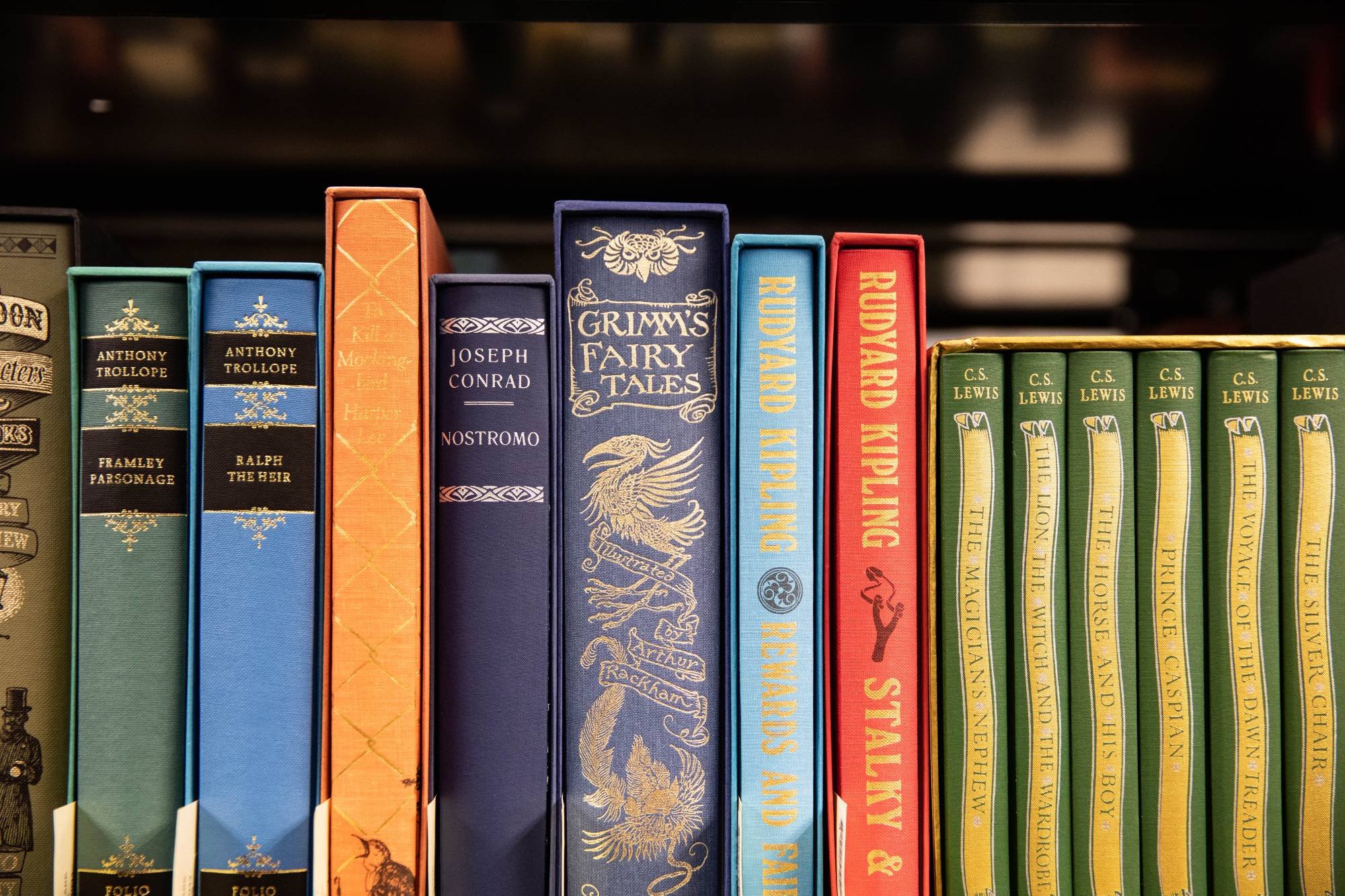A colorful display of books on a shelf including the Grimm's Fairy Tales